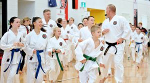 a group of students and an instructor learning about karate confidence