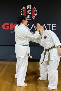 Sensei Charmaine demonstrating a move on a fellow karate-ka. international women's day 2022